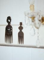 Ethnic-style decorated wooden combs hung on wall