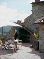 Dining area with parasol on Mediterranean terrace 