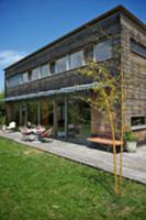 Contemporary house with wooden facade and seating 