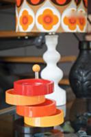 Cake stand with colourful plastic dishes in front 