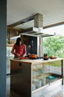 Teenager preparing food on kitchen island in open-