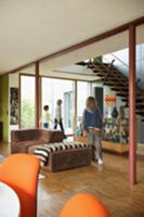 Children in open-plan room with 70s-style furnitur