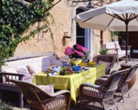 Rattan armchairs at summery set garden table