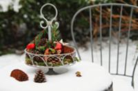 Metal cake stand with natural decorations and baub