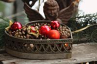 Heart-shaped basket filled with pine cones and bau