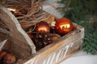 Wooden crate with pine cones and Christmas tree ba