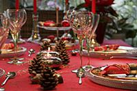 Table set and decorated in red for Christmas with 