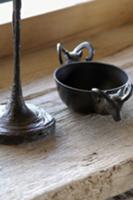 Small metal bowl decorated with ibex heads next to