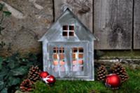 Festive garden decoration: little zinc cottage wit