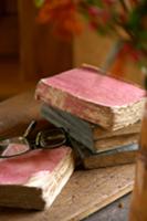 Antique, tattered books on a wooden surface and a 