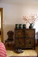 Old cans and pitcher on an antique chest of drawer