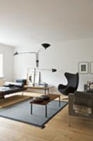 Living room in wood and shades of grey with couch,