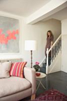 Lady going down stairs in a renovated country home