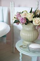 Bouquet of roses in a old-fashioned vase on an ant