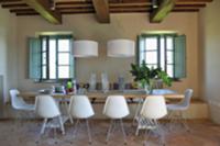 Dining area with white shell chairs and designer p