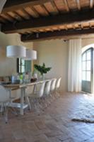 Dining area with white shell chairs on old terraco