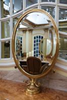 Hotel room reflected in free-standing mirror