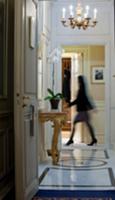 Woman walking through hallway in hotel