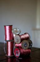 Old spools of thread on wooden table