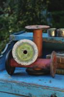 Old yarn spools on cabinet in garden