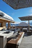 Set table on the wooden terrace of a hut in a snow