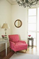 Antique armchair with ornamental pattern on pink b