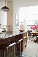 Open-plan kitchen with dining area and designer ba