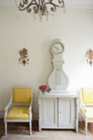 Baroque armchairs with yellow covers next to white