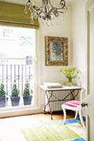 Table with metal frame and stone top in corner of 