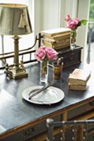 Breakfast plate and antiquarian books in front of 