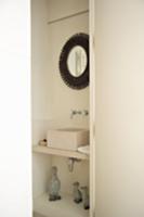 Niche in bathroom containing modern wash basin and