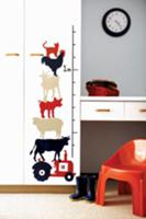 Animals painted next to a yardstick on the wall of