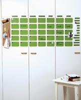 Calender made of green magnetic wafers on white ca