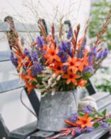 Summer bouquet in zinc pitcher on a garden bench