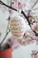 Easter egg decorated with handwriting hanging from