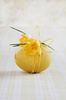 Boiled hen's egg dyed yellow and decorated with cr