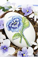 Goose egg decorated with pansy using napkin decoup