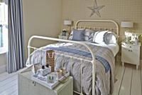White, metal double bed and tray on wicker trunk i