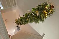 View down staircase with festively decorated handr