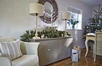 White-painted wicker armchair next to festive arra