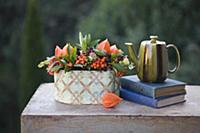 Autumn still-life arrangement of berries, teapot a