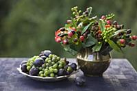 Autumn posy of St John's wort berries in brass vas