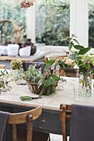 Autumnal bouquets in basket and glass vase