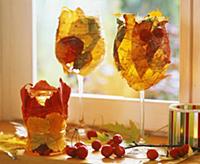 Wine glasses wrapped with autumn leaves and wire