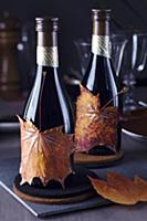 Small wine bottles decorated with painted autumn l