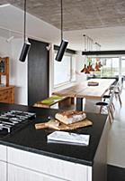 Bread on island counter and dining table with wood