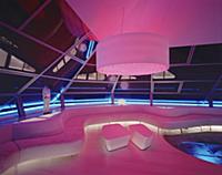 Futuristic living room illuminated in pink and blu