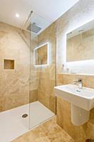 Mirror with indirect lighting in bathroom in sandy