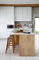 Island counter and wooden bar stools in elegant wh