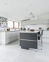 Modern grey-and-white kitchen-dining room with slo